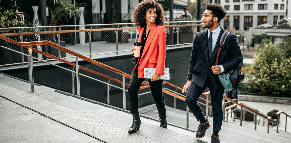 Black man and woman walking up stairs