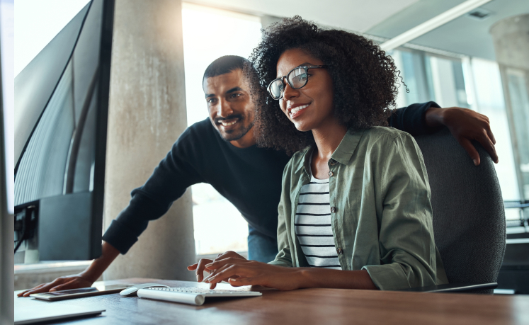 Man and woman looking at computer